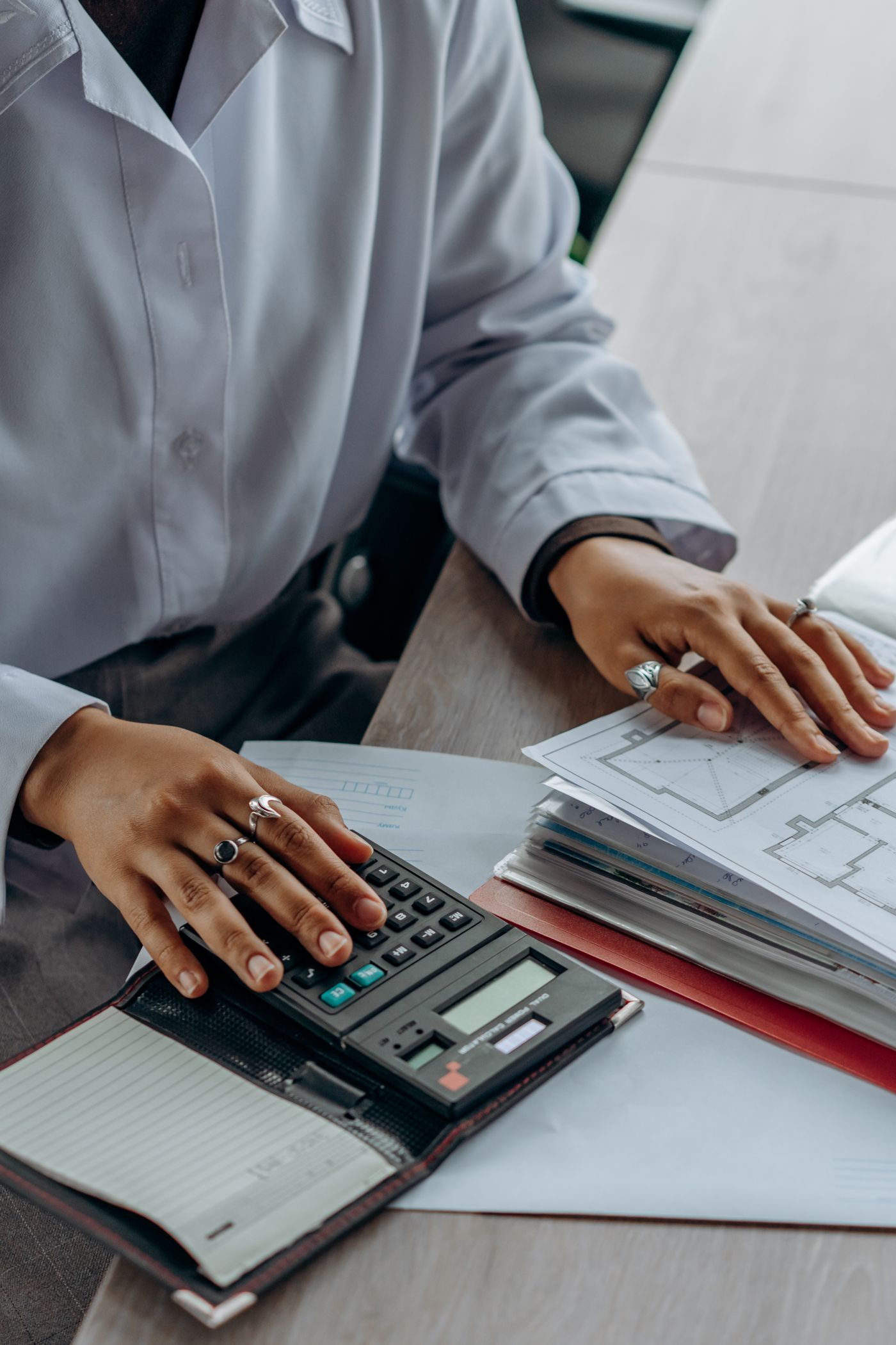 Professional reviewing financial documents with a calculator
